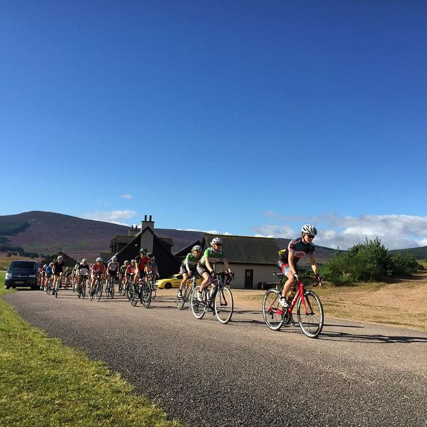 Eine Gruppe von Menschen, die mit dem Fahrrad fahren und den Himmel im Hintergrund haben.