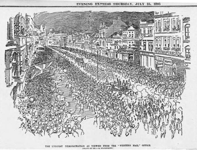 Schwarze und weiße Zeichnung einer Menge von Menschen, die eine Straße mit Gebäuden entlang gehen, mit Text oben und unten, der "Die Unionistendemonstration, wie sie vom Western Mail Office aus gesehen wird" liest.