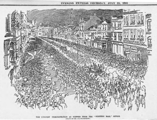 Schwarze und weiße Zeichnung einer Menge von Menschen, die eine Straße mit Gebäuden entlang gehen, mit Text oben und unten, der "Die Unionistendemonstration, wie sie vom Western Mail Office aus gesehen wird" liest.