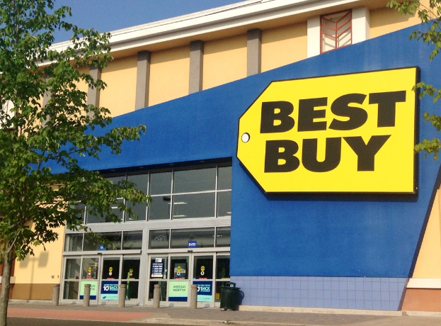 Ein Gebäude mit einem "Best Buy"-Schild, das eine Tür und mehrere Bäume draußen zeigt.