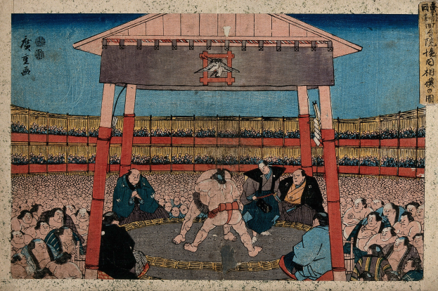 Ein Gemälde eines Sumo-Kampfes in einem Stadion mit einigen Menschen im Vordergrund und einer Hütte im Hintergrund von Utagawa Kunisada Toyokuni III aus der Serie Fifty-Three Stations of the Tokaido.
